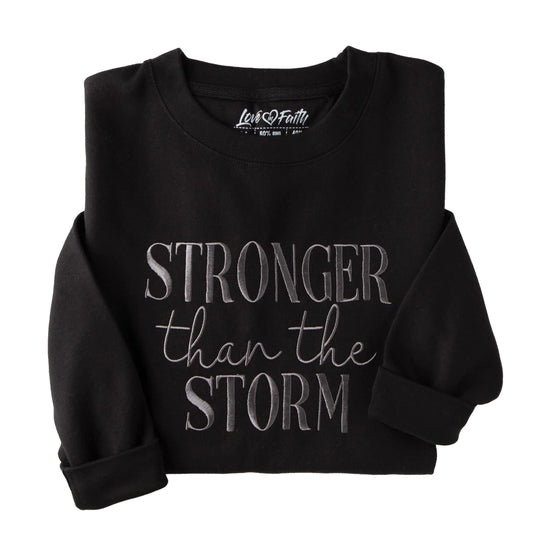 Love in Faith | Stronger Than The Storm Embroidered Sweater | Christian Crewneck Sweatshirts | Faith-Based Apparel | Unisex (US Alpha 3X-Large Regular Regular Black)